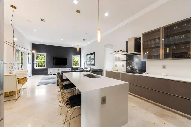 a large kitchen with a large counter top appliances and a center island