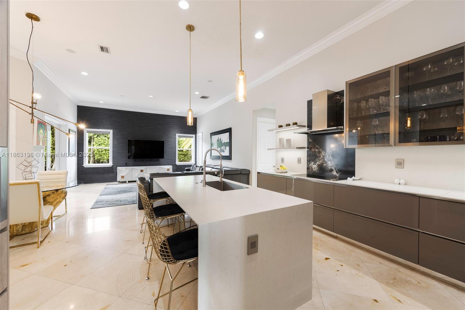 9445 Southwest 68th Street Miami, FL 33173 - Photo 14 of 41 a large kitchen with a large counter top appliances and a center island