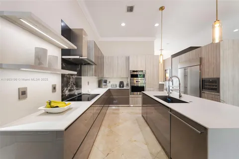 a kitchen with stainless steel appliances a sink a counter top space appliances and cabinets