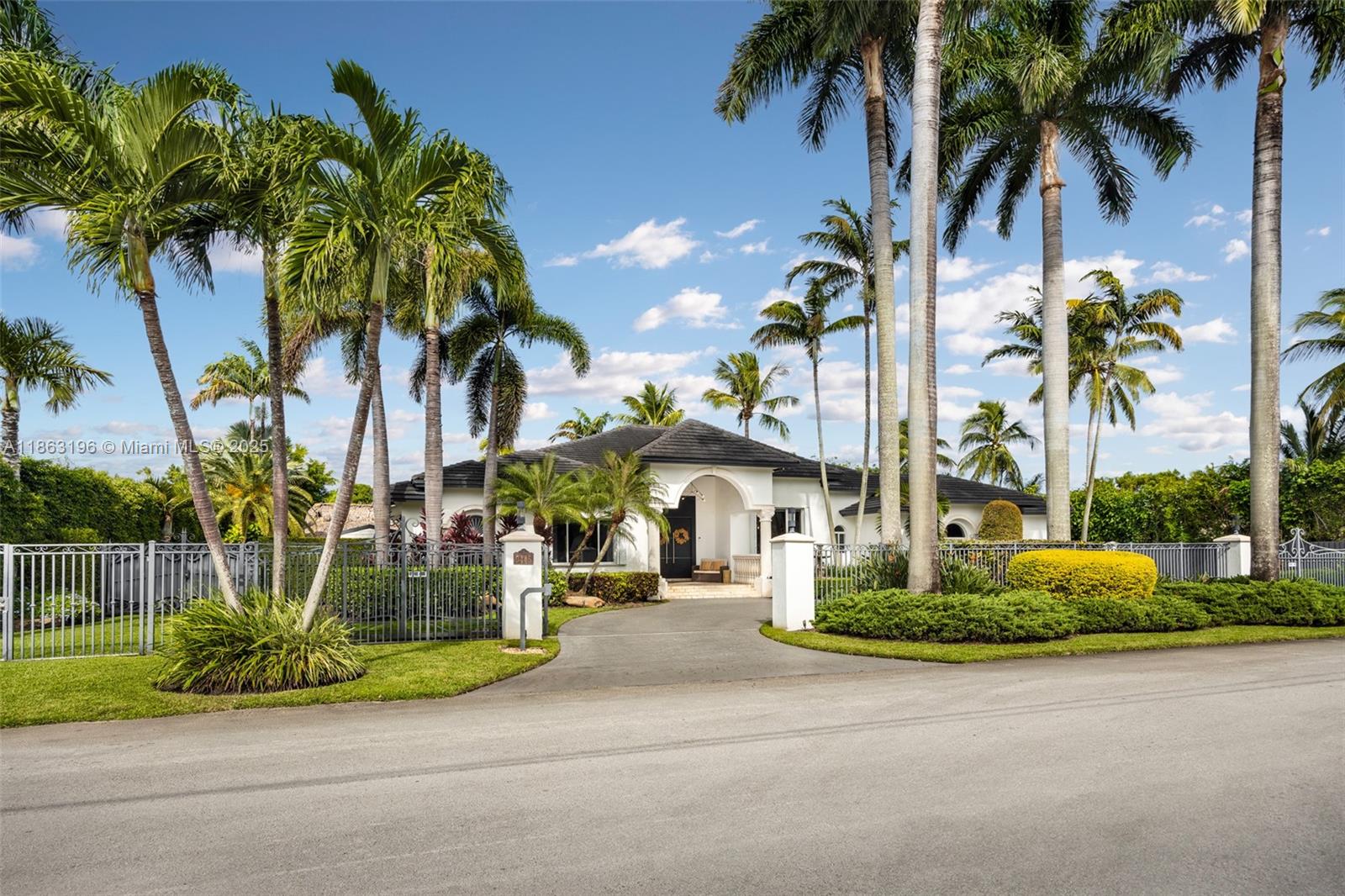 9445 Southwest 68th Street Miami, FL 33173 - Photo 3 of 41 a view of a street with palm trees
