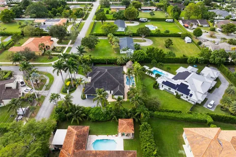 an aerial view of residential houses with outdoor space and street view