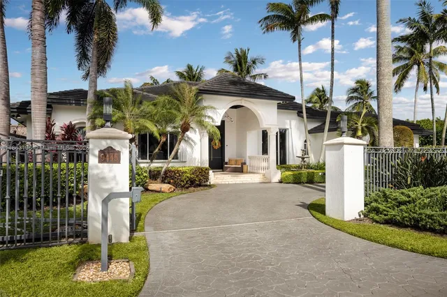 a front view of multi story residential apartment building with a garden