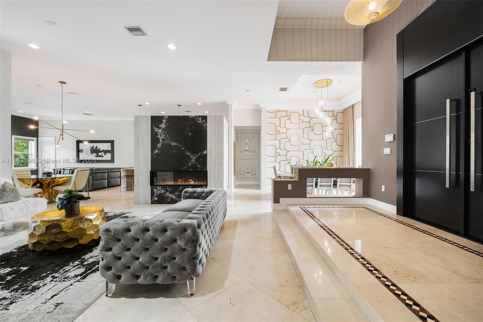 9445 Southwest 68th Street Miami, FL 33173 - Photo 6 of 41 a living room with furniture a large window and a chandelier