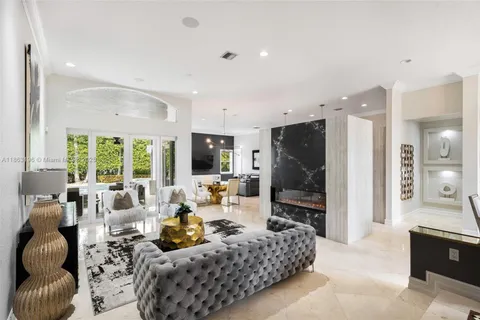 a living room with furniture a large window and a flat screen tv