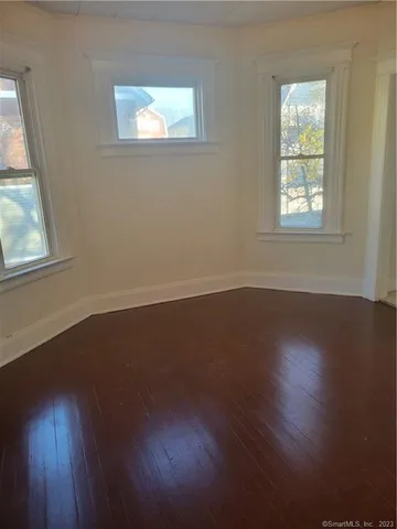 a view of wooden floor and windows in a room