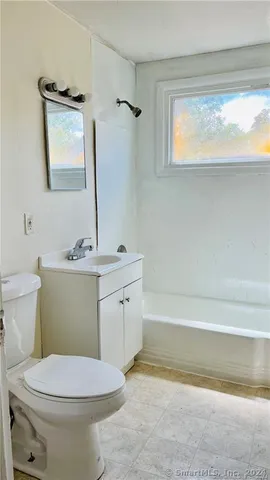 a bathroom with a sink a toilet and bathtub