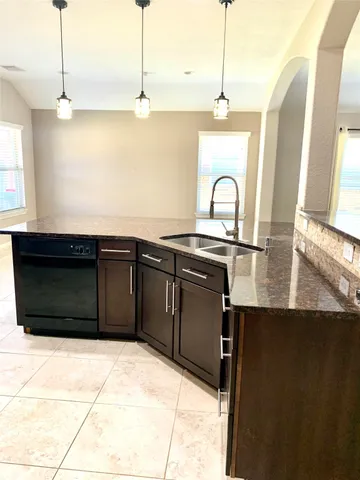 a kitchen with a sink and cabinets