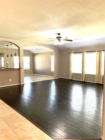 a view of a living room with kitchen countertops and wooden floor