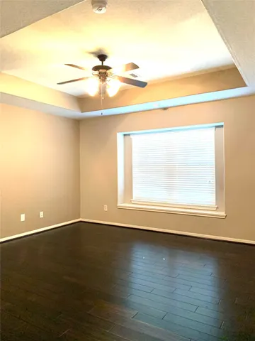 a view of a room with wooden floor and a window
