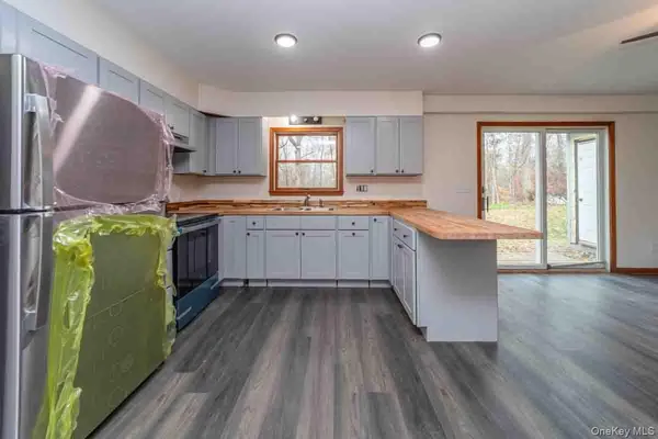 a kitchen with sink cabinets and wooden floor