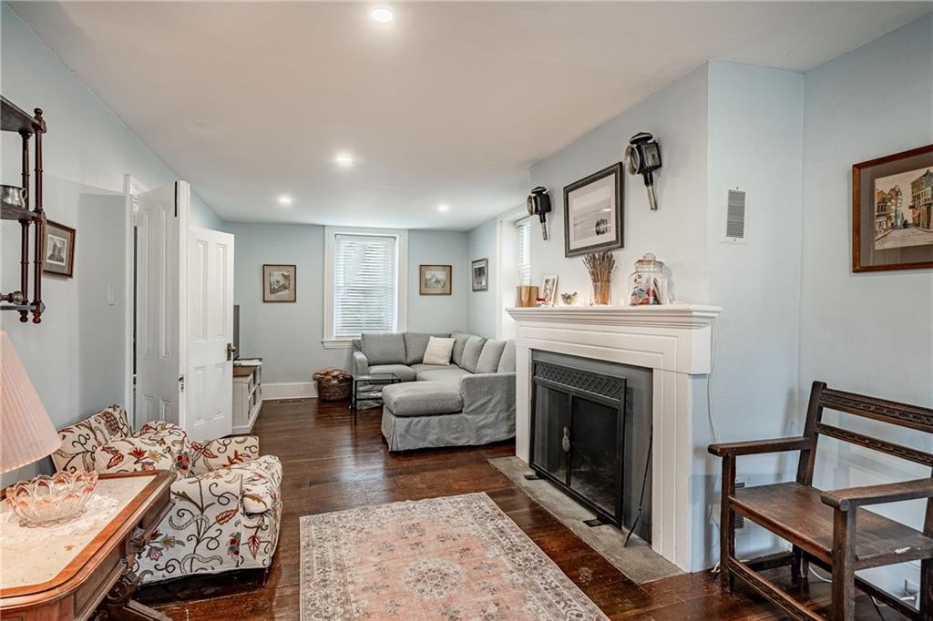 701 Oakbourne Road West Chester, PA 19382 - Photo 7 of 50 a living room with furniture a fireplace and wooden floor