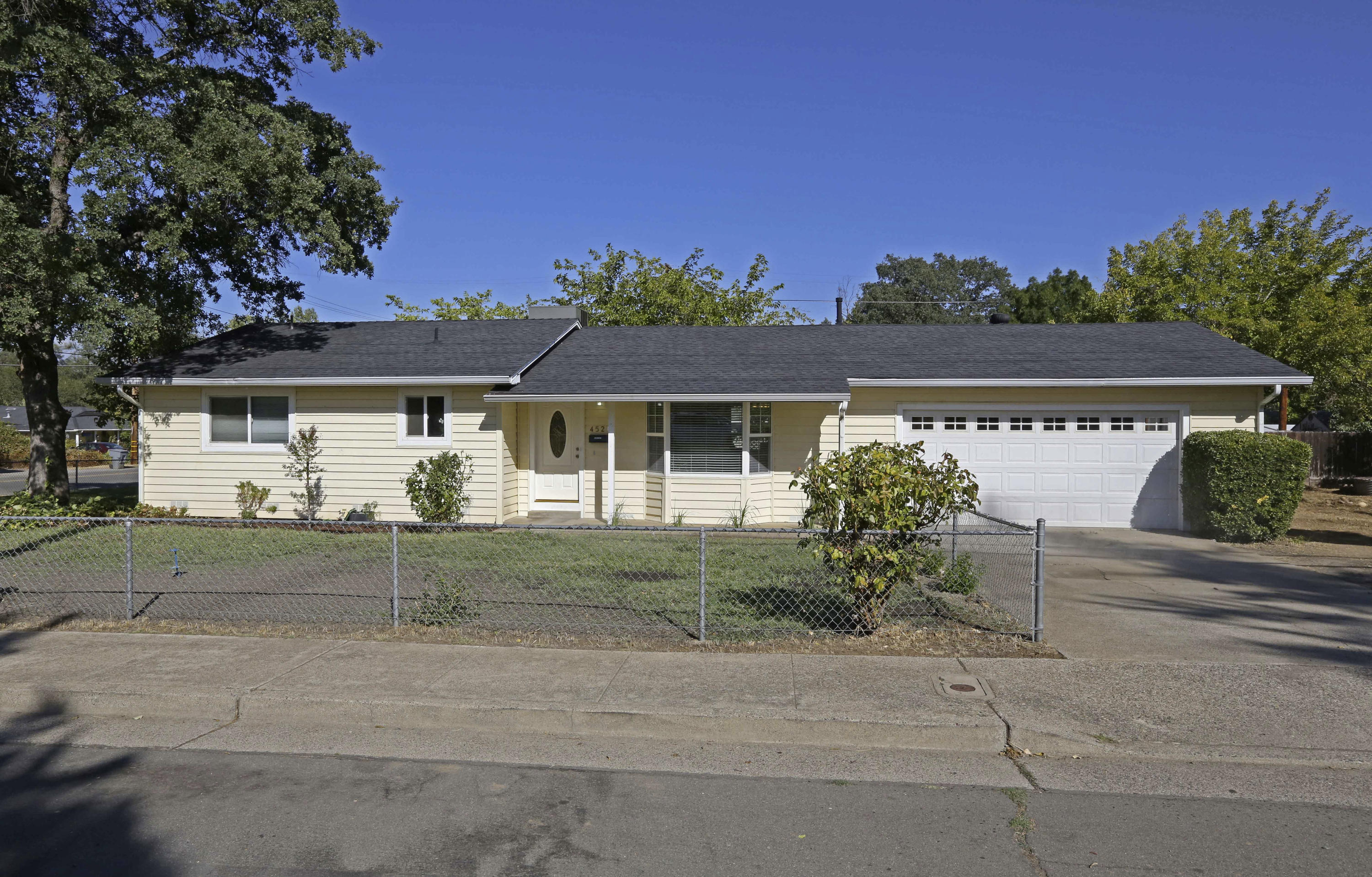 4521 Cedars Road Redding, CA 96001 - Photo 1 of 13 front view of a house with a yard