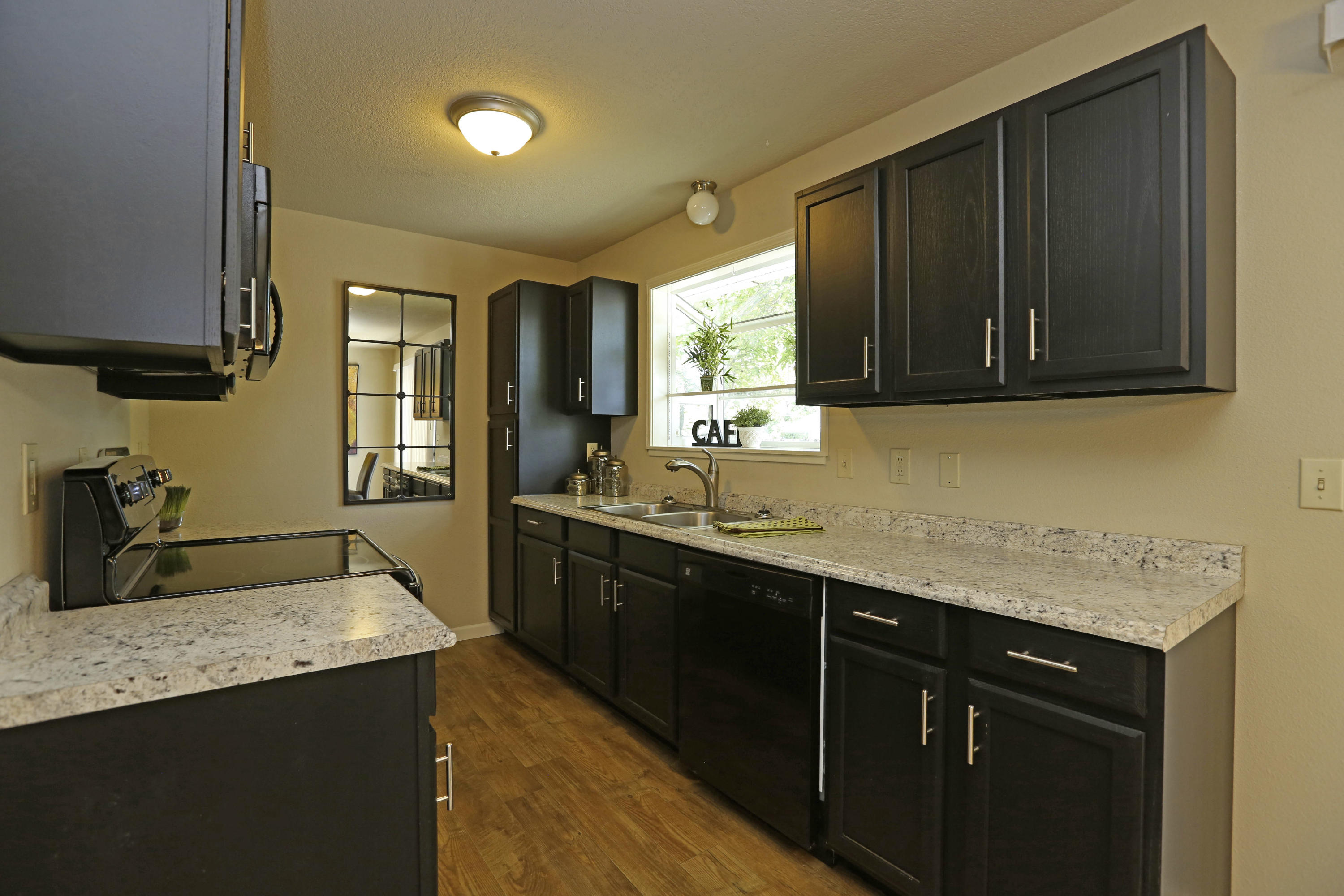 4521 Cedars Road Redding, CA 96001 - Photo 5 of 13 a kitchen with stainless steel appliances granite countertop a sink stove and cabinets