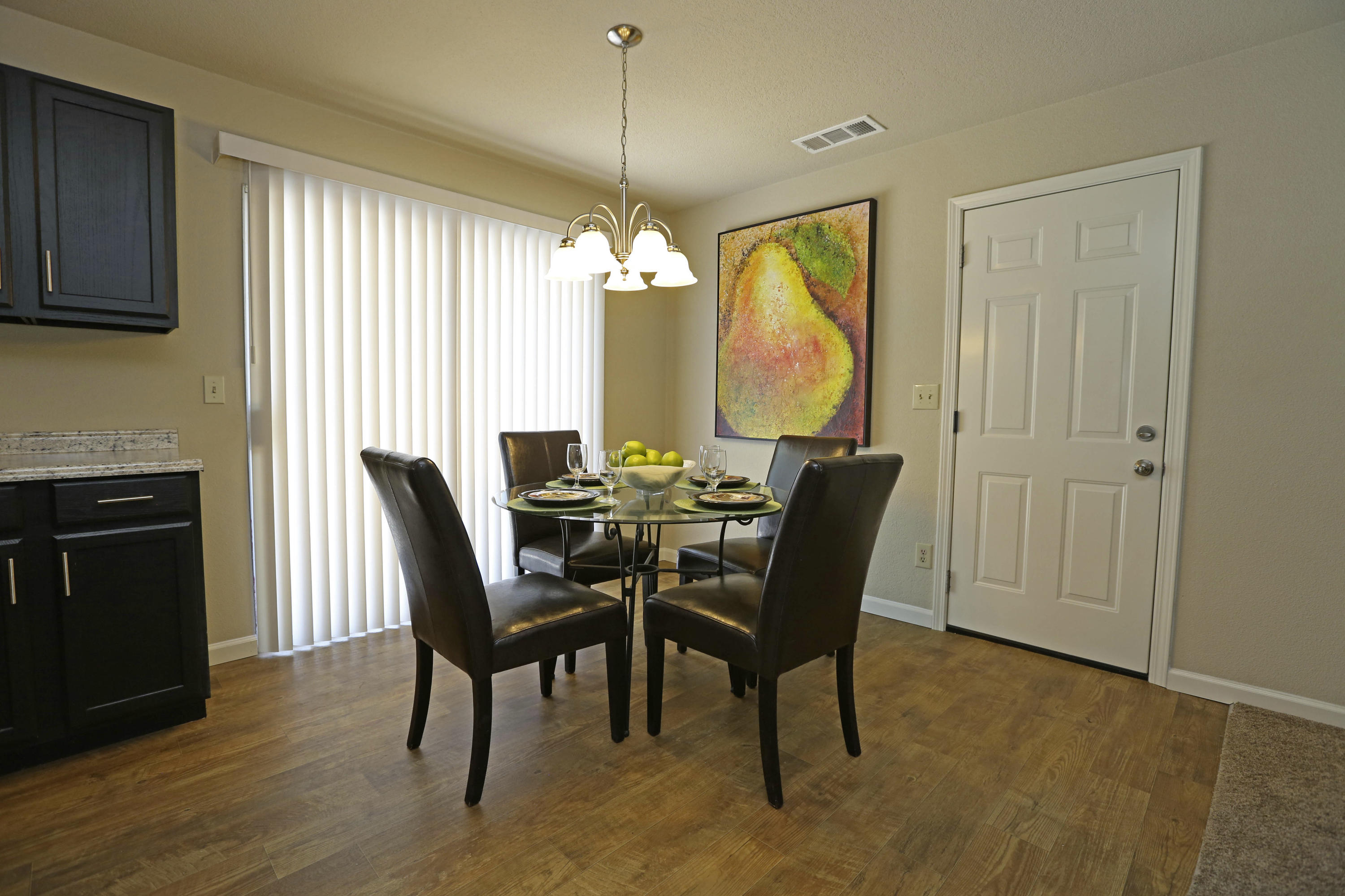 4521 Cedars Road Redding, CA 96001 - Photo 6 of 13 a dining room with furniture a chandelier and wooden floor