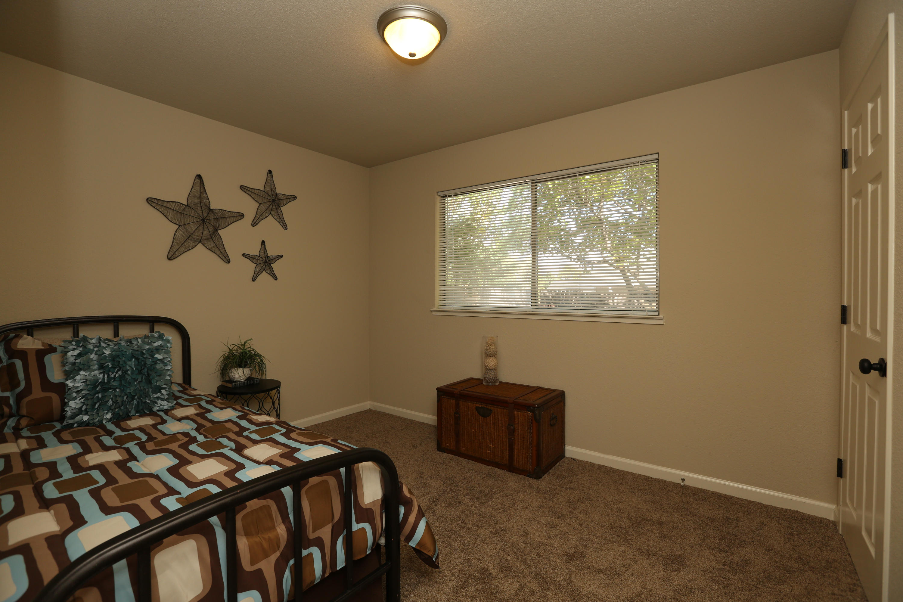 4521 Cedars Road Redding, CA 96001 - Photo 8 of 13 a bedroom with bed and a window