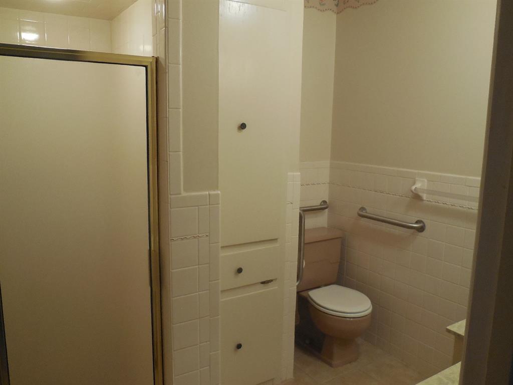 820 Walnut Street Ranger, TX 76470 - Photo 11 of 21 a white toilet sitting next to a shower