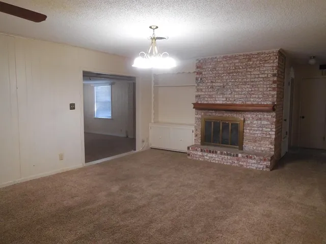 an empty room with a fireplace