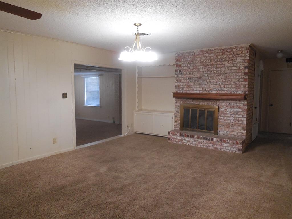 820 Walnut Street Ranger, TX 76470 - Photo 7 of 21 an empty room with a fireplace