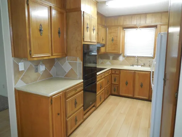 a kitchen with a sink cabinets and window