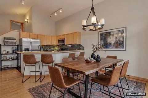 a view of a dining room with furniture wooden floor and a chandelier