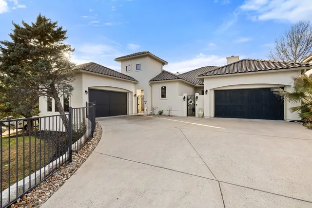 a view of a house with a balcony and yard