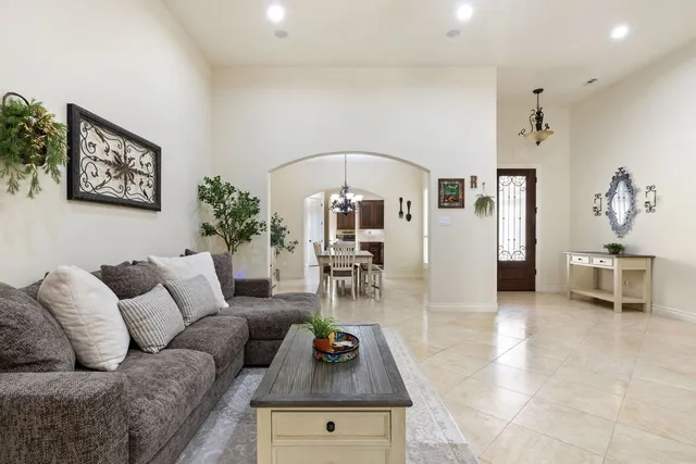 a living room with furniture and a chandelier