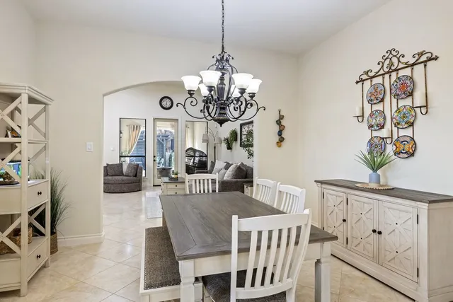 a view of a dining room with furniture and chandelier