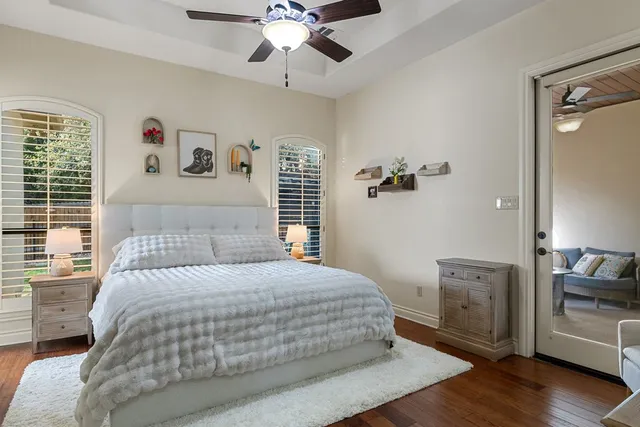 a bedroom with a large bed and a chandelier