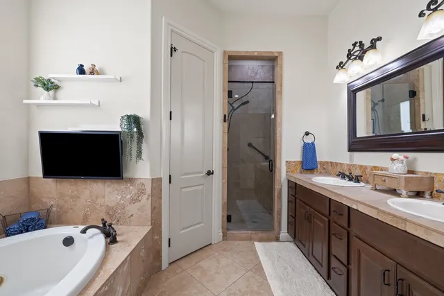 a bathroom with a tub a sink and a mirror