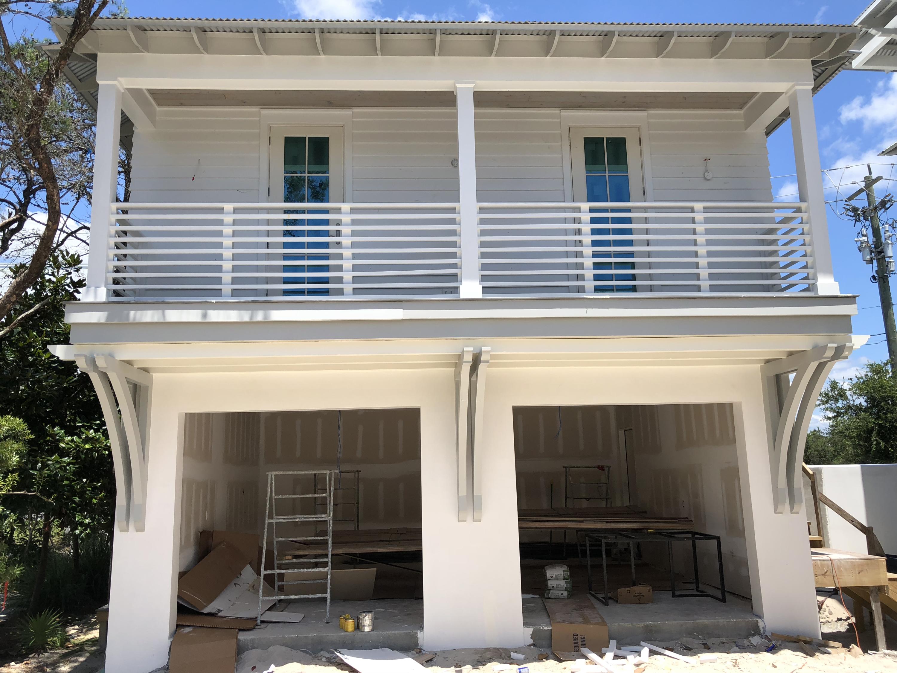 94 Pine Crest Circle Rosemary Beach, FL 32461 - Photo 20 of 24 a front view of a house with glass windows and garage