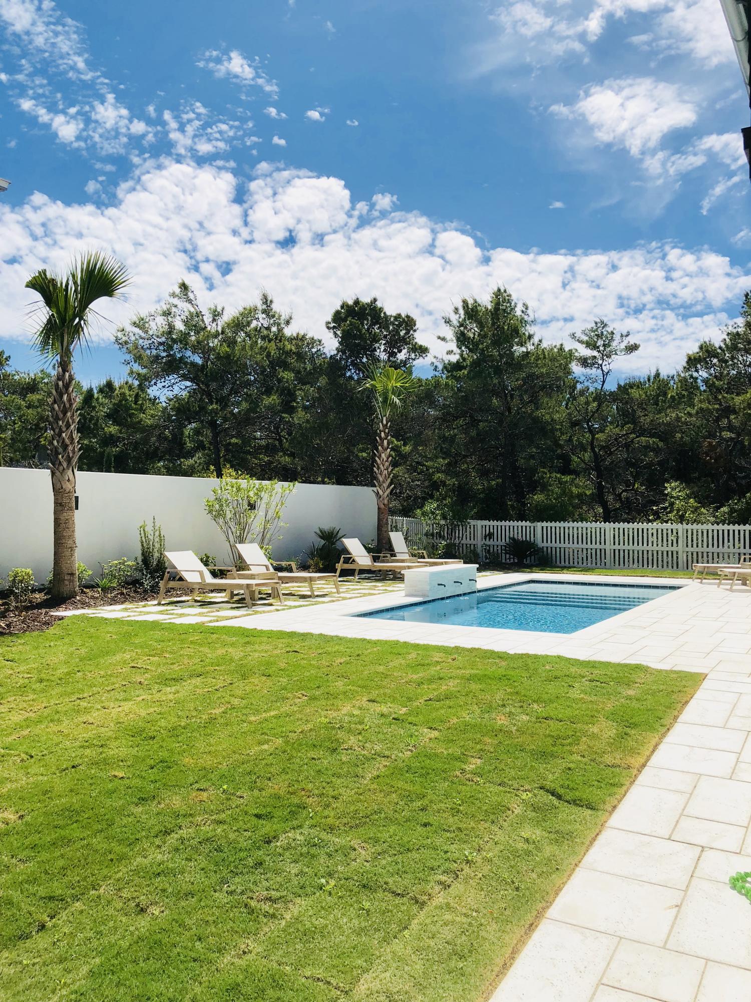 94 Pine Crest Circle Rosemary Beach, FL 32461 - Photo 4 of 24 a view of a swimming pool with a yard