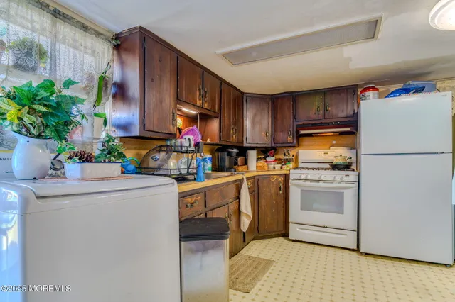 a kitchen with appliances cabinets and a counter top space