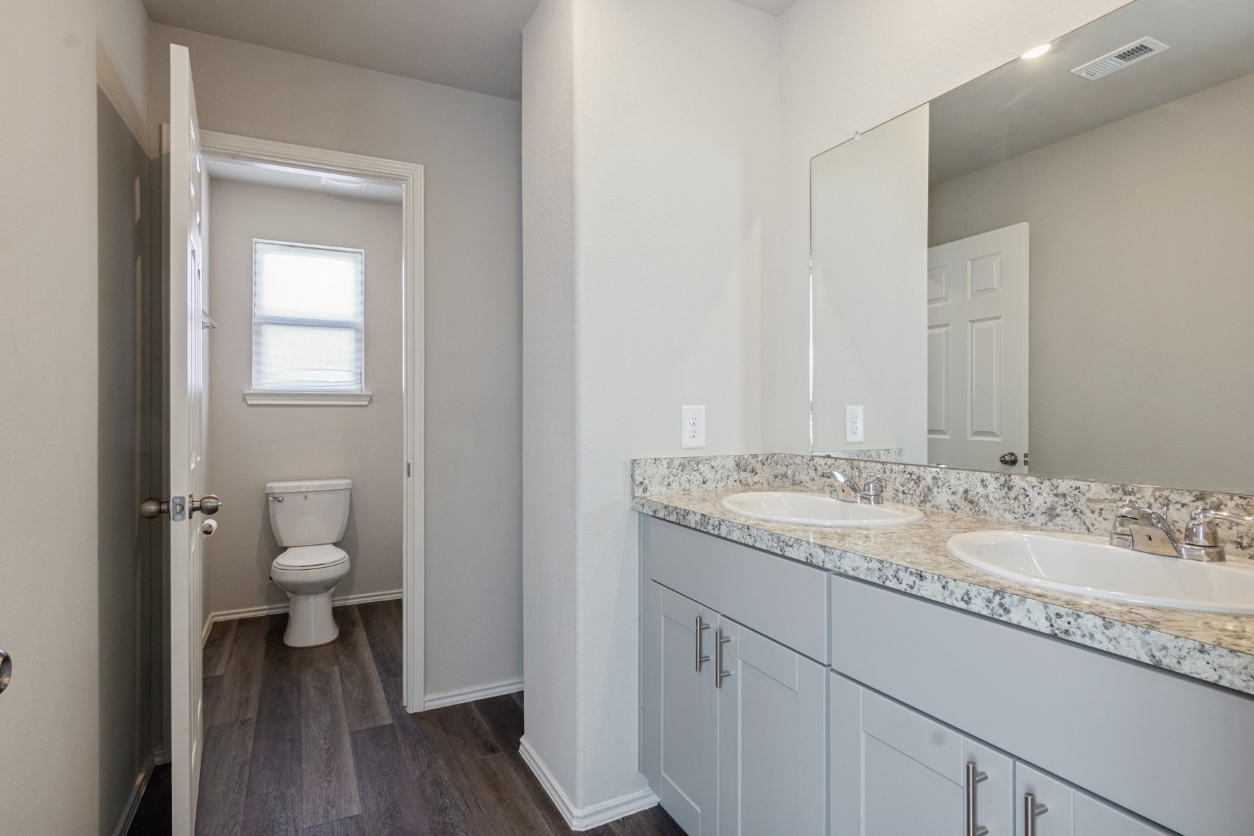 2250 Yelverton Ter Trail Spring, TX 77373 - Photo 24 of 30 a bathroom with a granite countertop toilet a sink and a mirror