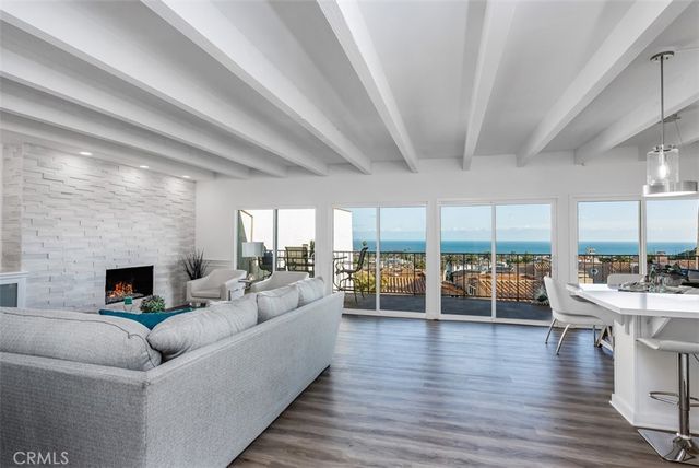 a living room with furniture wooden floor and a fireplace