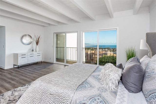 a bed room with a bed and a large window