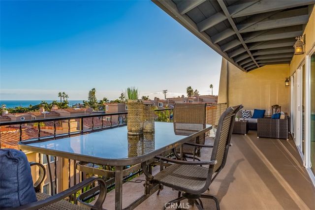 a view of a chairs and table in the balcony