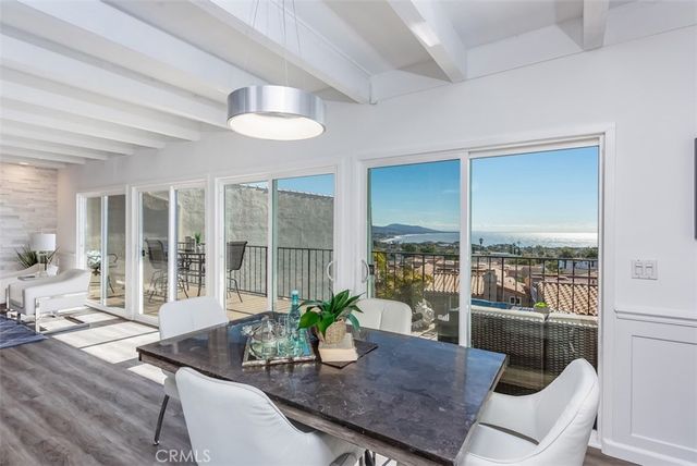 a view of a dining room with furniture wooden floor and a potted plant