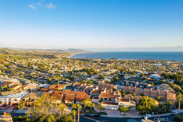 an aerial view of residential building and ocean