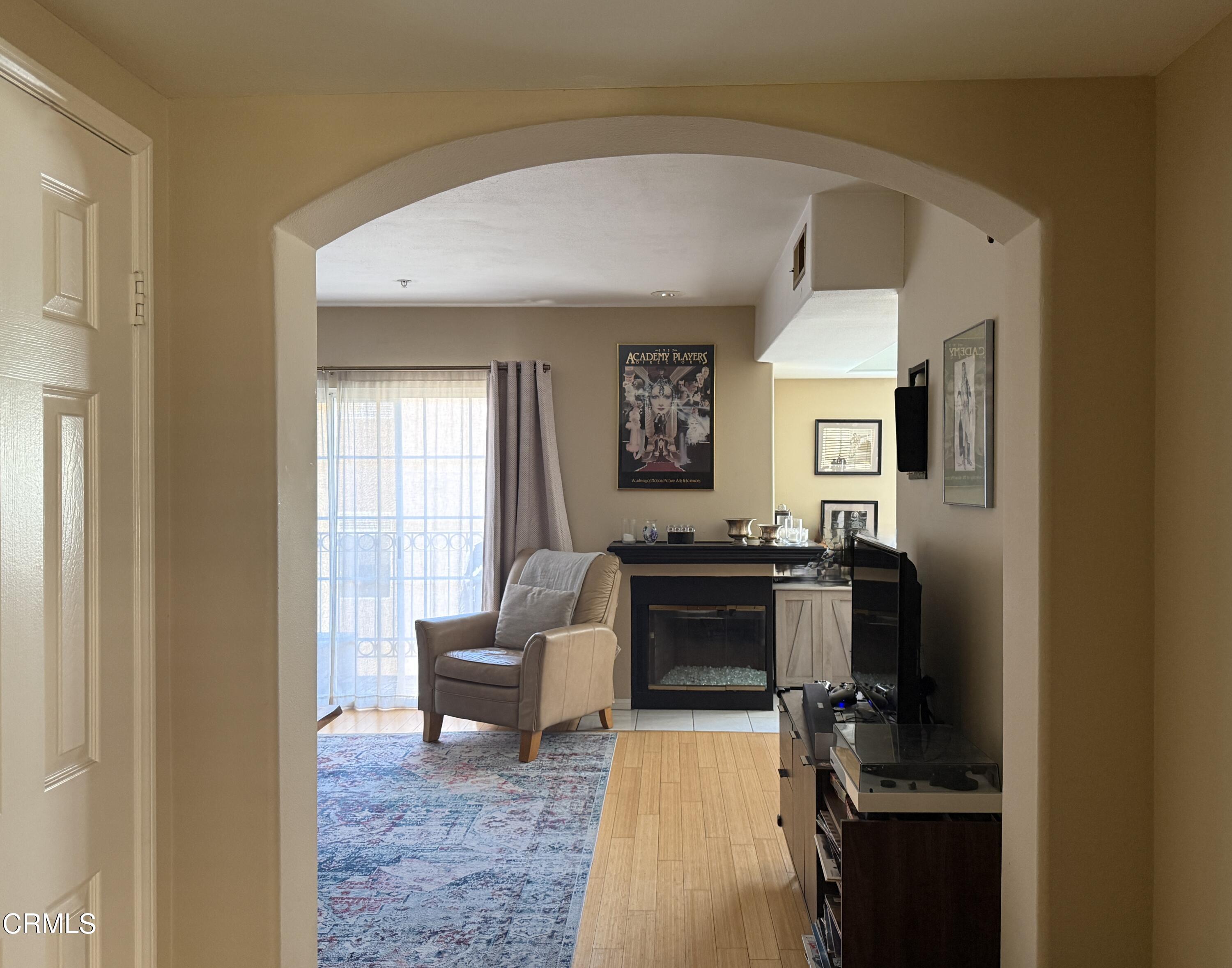 4259 Fulton Avenue, Unit 307 Sherman Oaks, CA 91423 - Photo 3 of 17 a living room with furniture and a fireplace