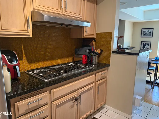 a stove top oven sitting inside of a kitchen