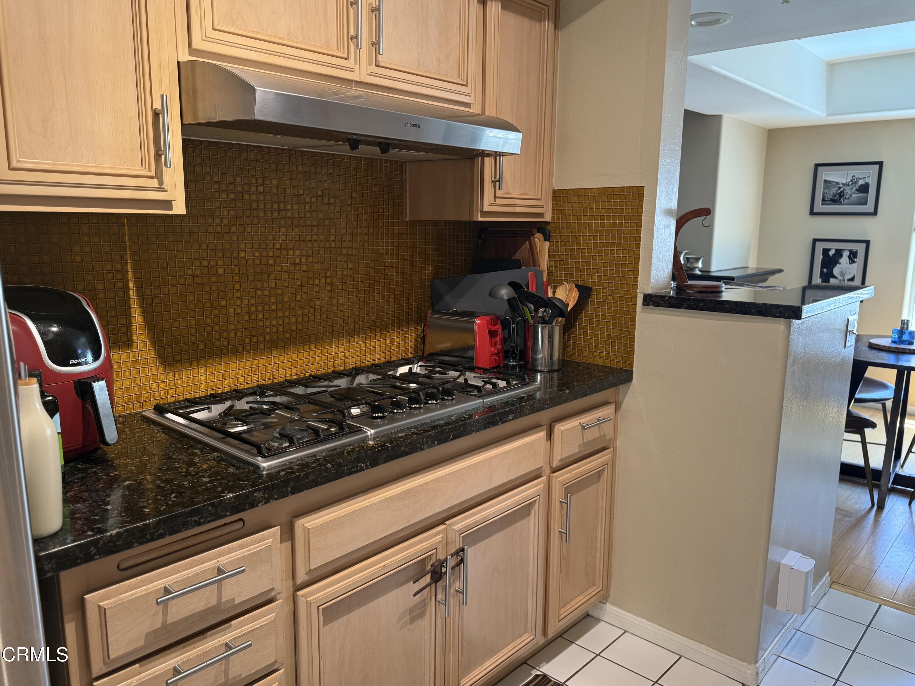 4259 Fulton Avenue, Unit 307 Sherman Oaks, CA 91423 - Photo 5 of 17 a stove top oven sitting inside of a kitchen