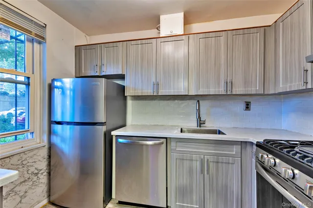 a kitchen with a refrigerator sink and cabinets