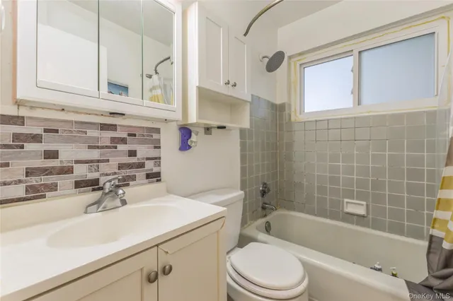 a bathroom with a sink a toilet and bathtub