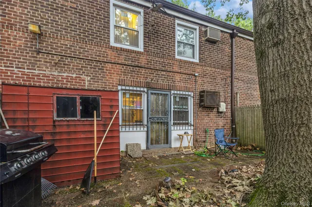 a backyard of a house with barbeque oven