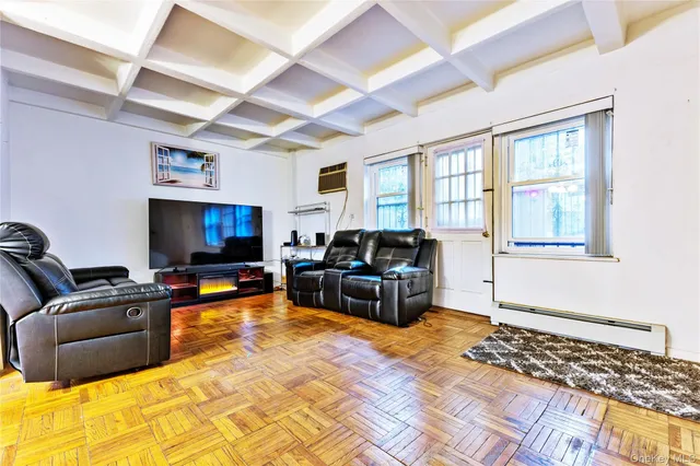 a living room with furniture window and a flat screen tv