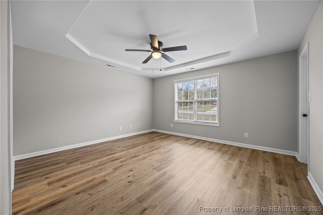216 Cobblestone Drive Spring Lake, NC 28390 - Photo 11 of 38 a view of an empty room with wooden floor and a window
