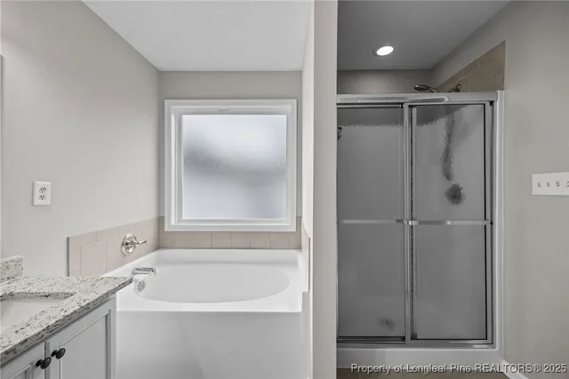 a bathroom with a granite countertop sink mirror and vanity