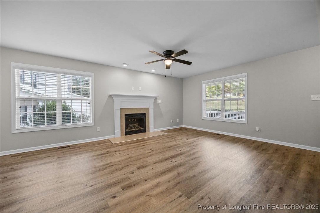 216 Cobblestone Drive Spring Lake, NC 28390 - Photo 22 of 38 a view of an empty room with a window and wooden floor