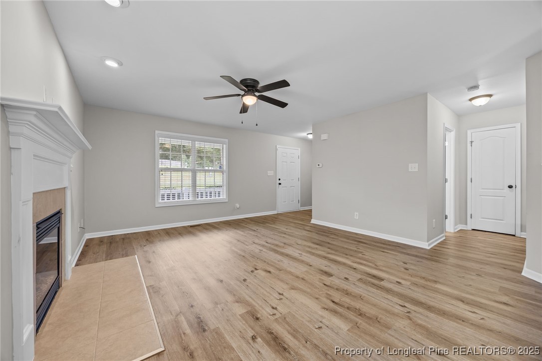 216 Cobblestone Drive Spring Lake, NC 28390 - Photo 23 of 38 a view of an empty room with a window and wooden floor