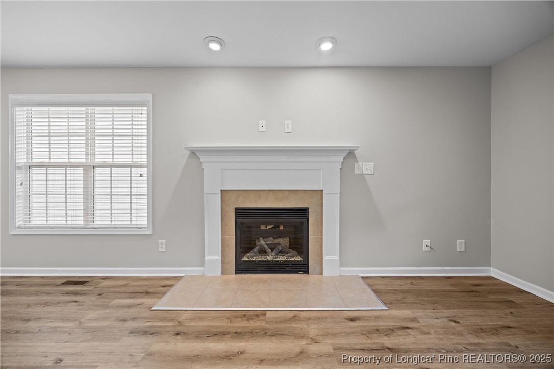 216 Cobblestone Drive Spring Lake, NC 28390 - Photo 24 of 38 a living room with a fireplace and a fireplace